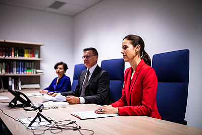 Two women and a man sitting at a desk